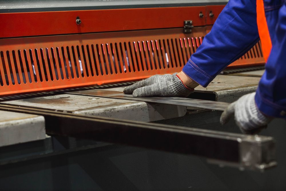 Cutting Sheet Metal in Large Hydraulic Guillotine Shears — Skilled Labour Hire in Townsville, QLD