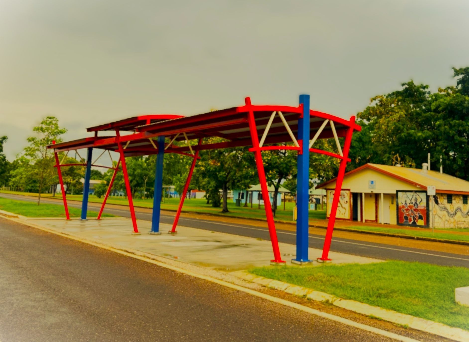 Red and Blue Bus Stop Shelter on a Road — Custom Steel Fab in Garbutt, QLD