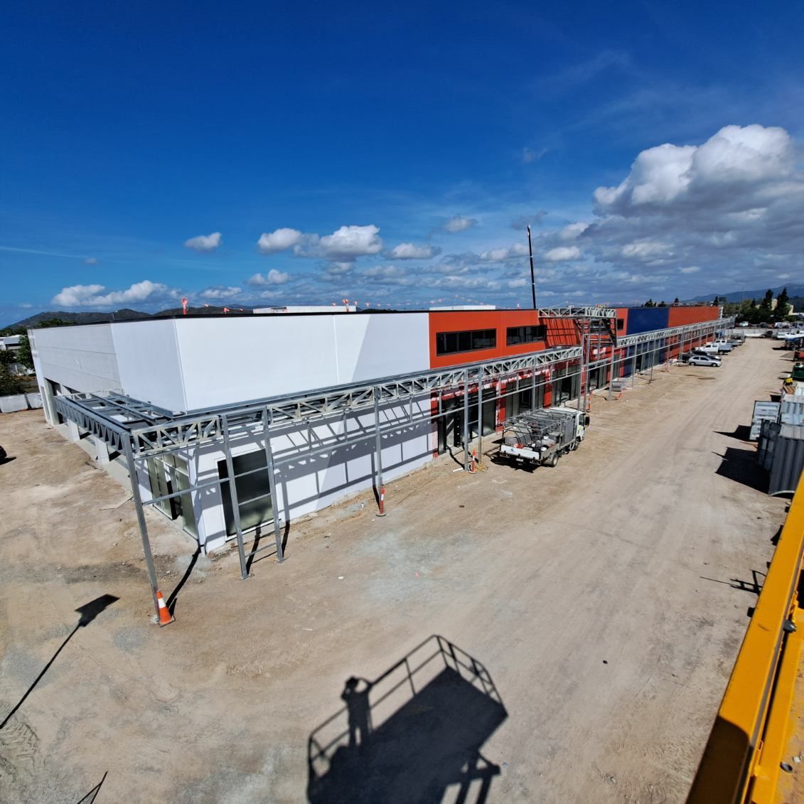 Construction Site With a Long, Multi-colored Building Under a Blue Sky — Norfab In Bohle, QLD