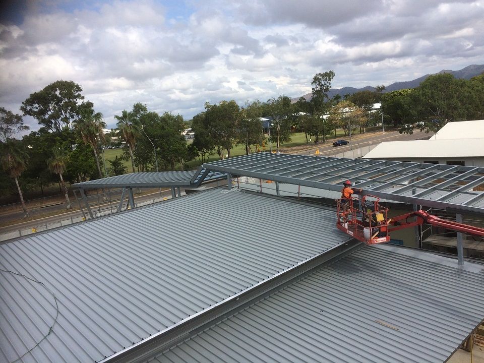 Workers in a Crane Lift Over a Metal Roof — Our Completed Projects in Townsville, QLD