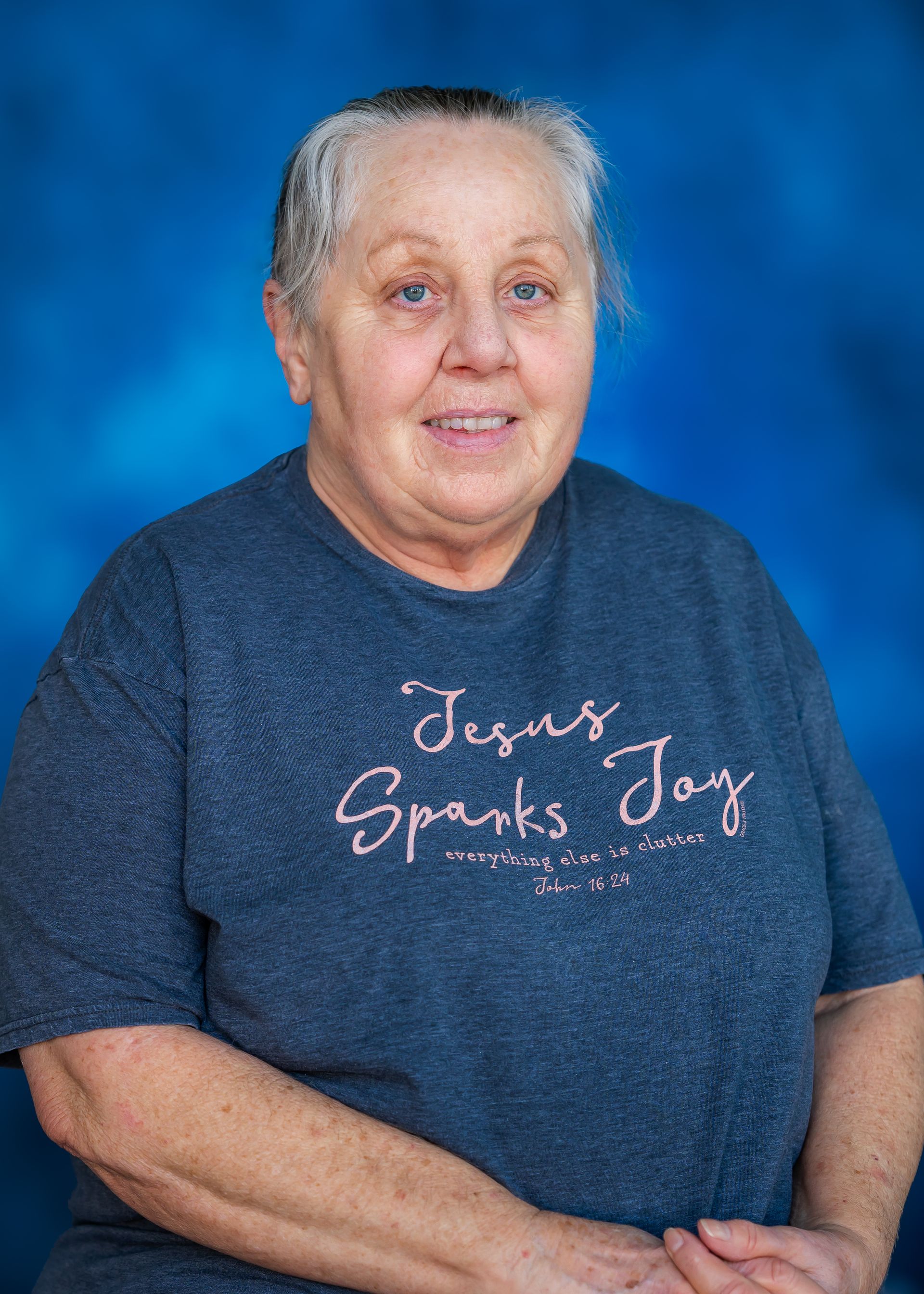Woman wearing a navy shirt that reads 