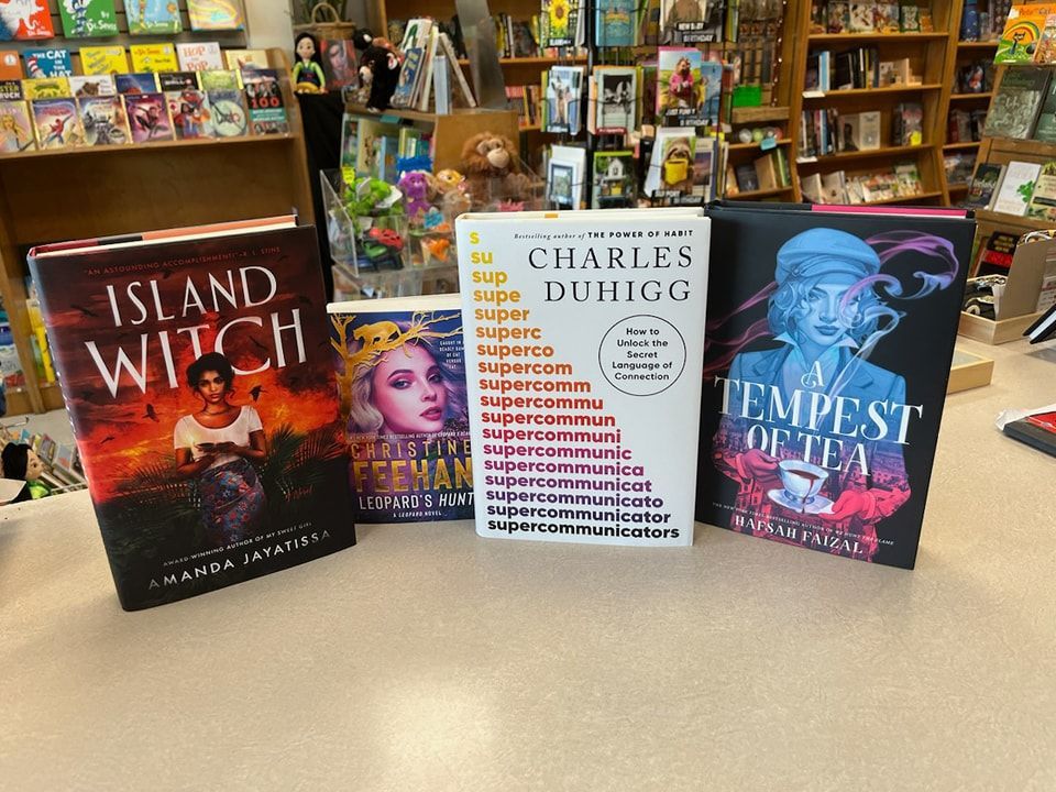 Four books displayed on a counter: