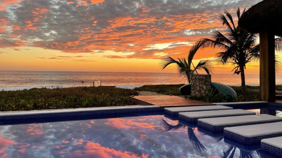 Sunset over ocean and pool at Vivo Resort.
