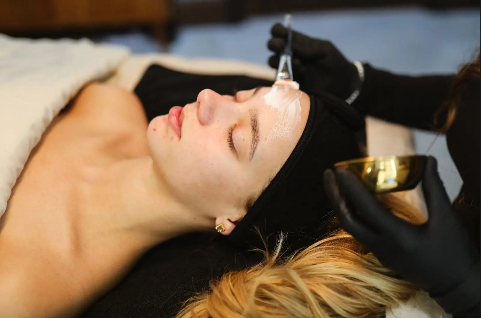 A woman is getting a facial treatment at a spa.