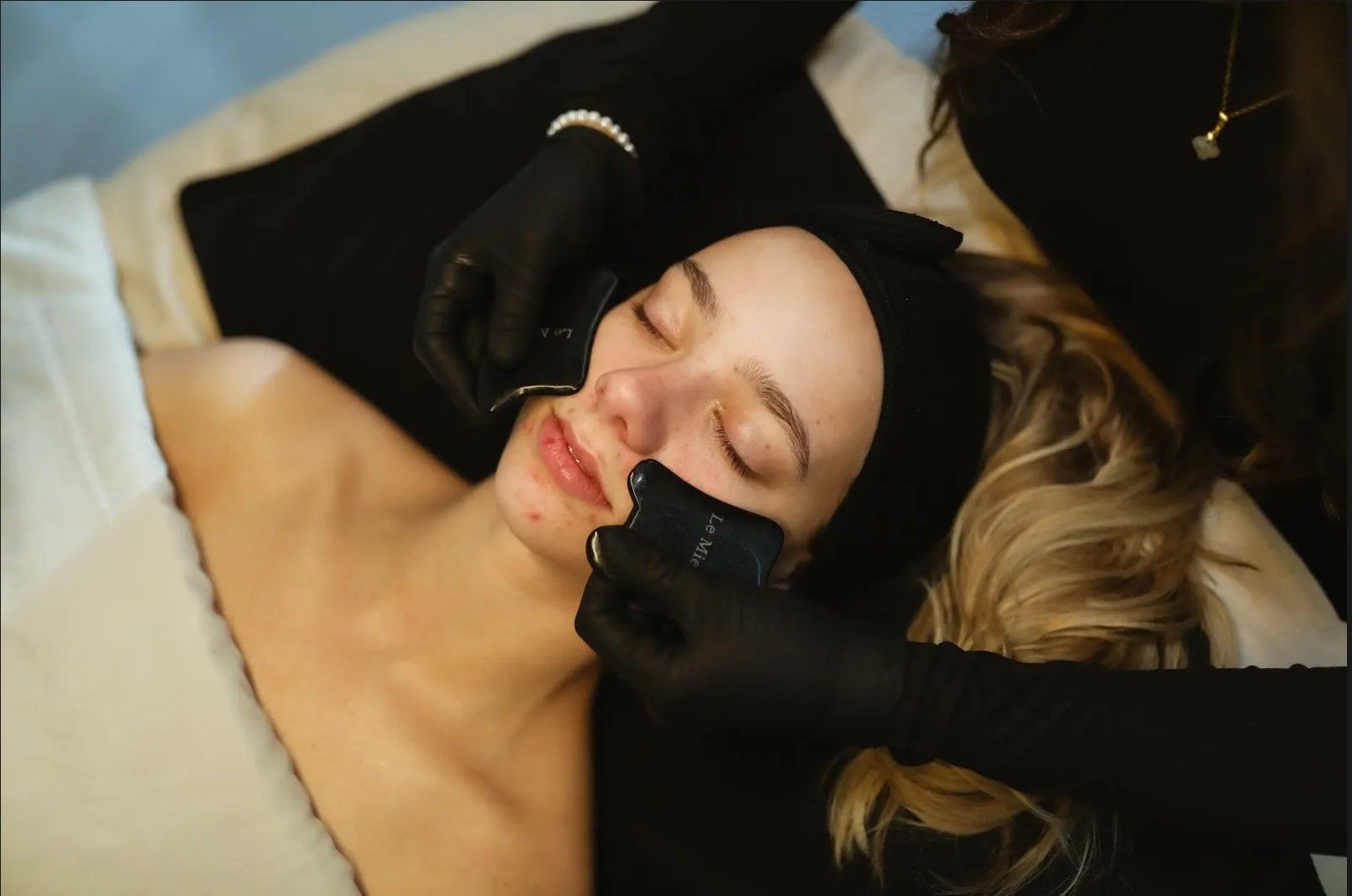 A woman is getting a facial treatment at a spa.