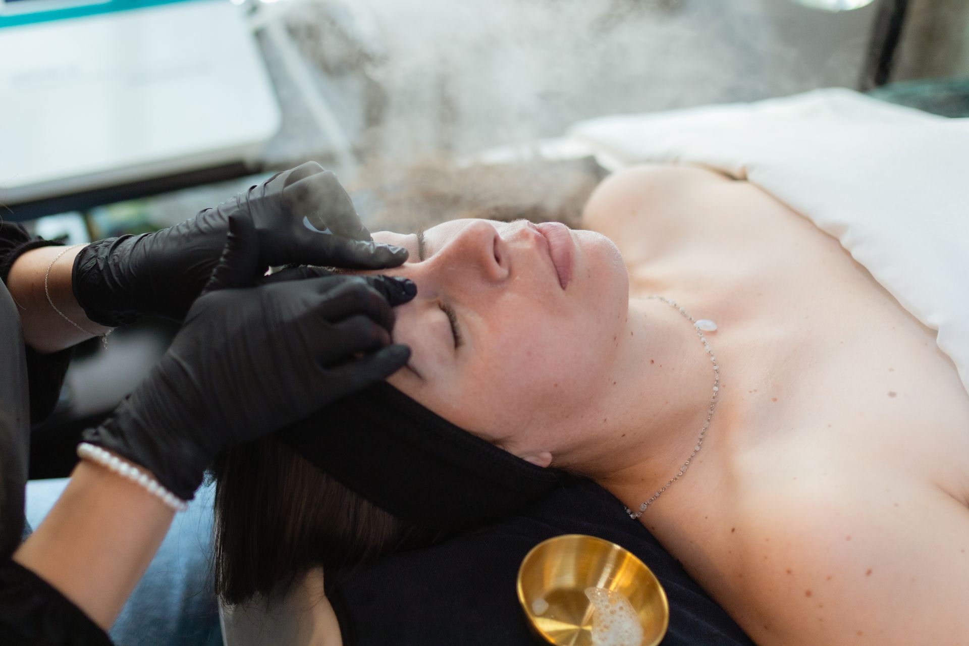 A woman is getting a facial treatment at a spa.
