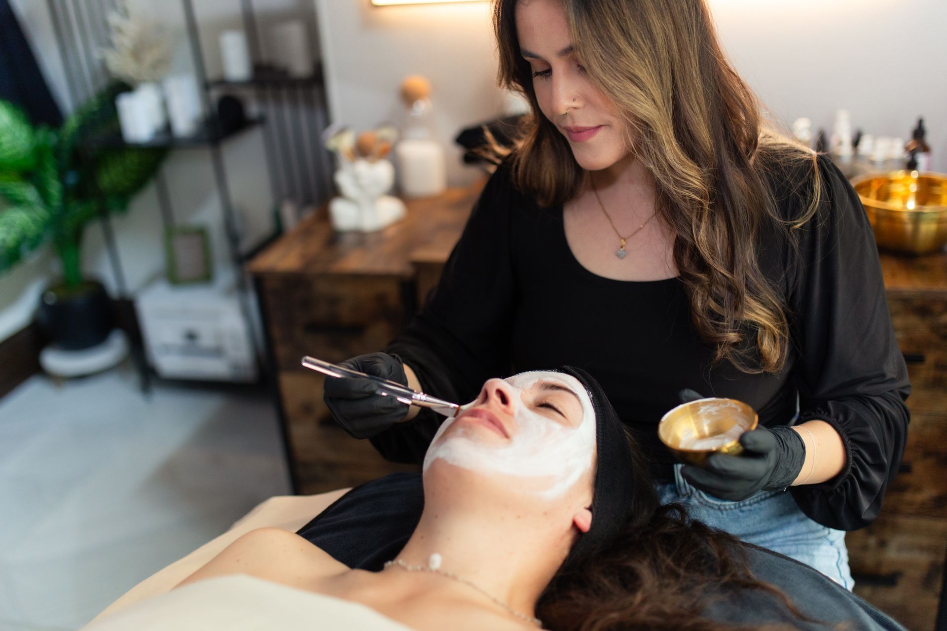 A woman is getting a facial treatment at a spa.