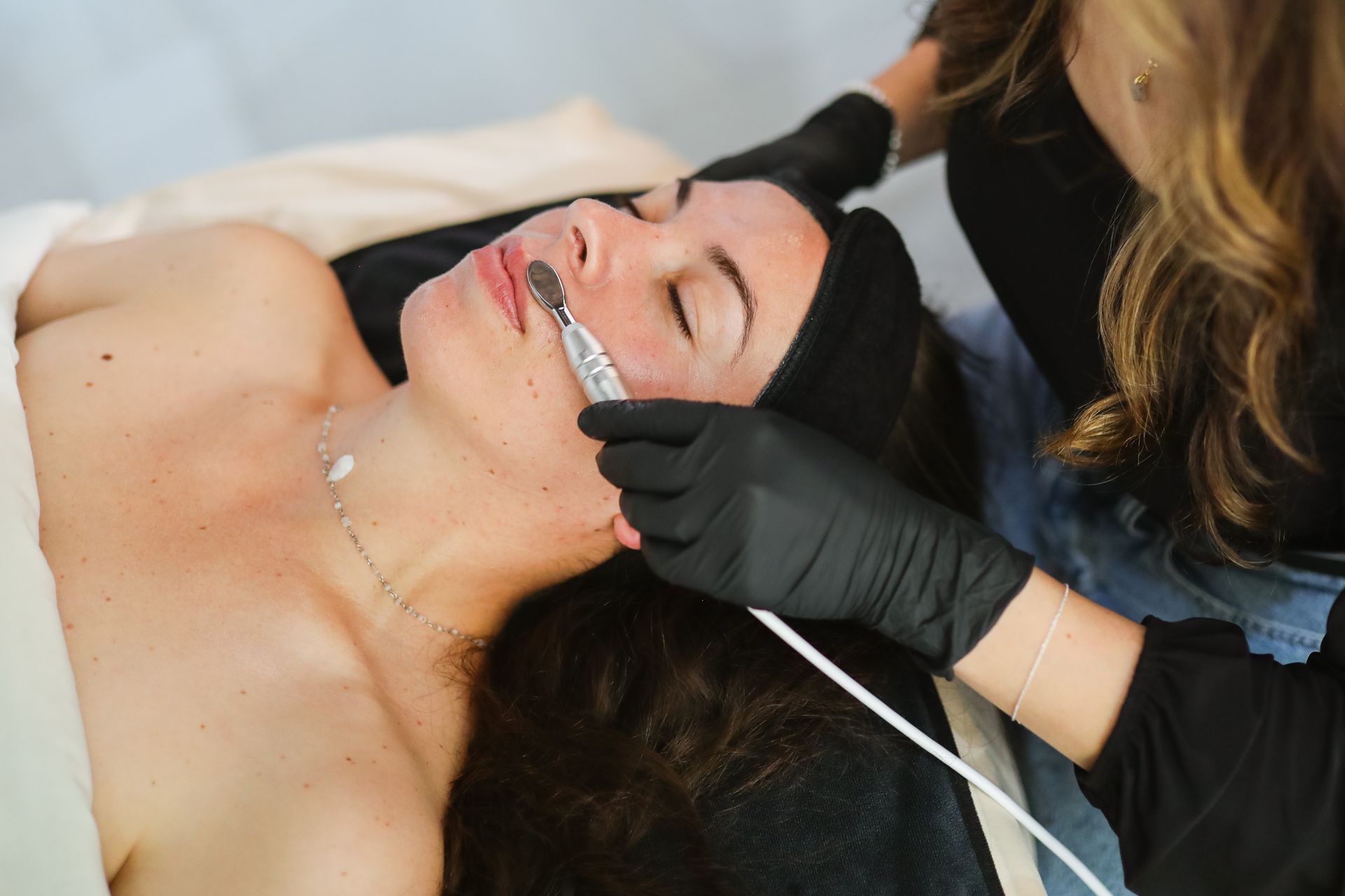 A woman is getting a facial treatment at a spa.