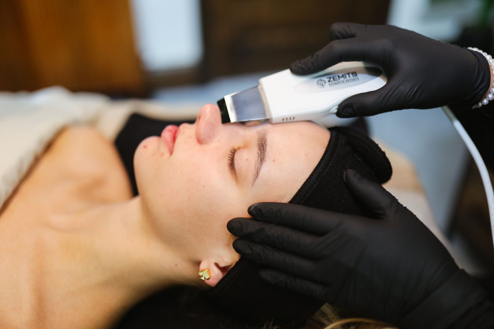 A woman is getting a facial treatment at a beauty salon.