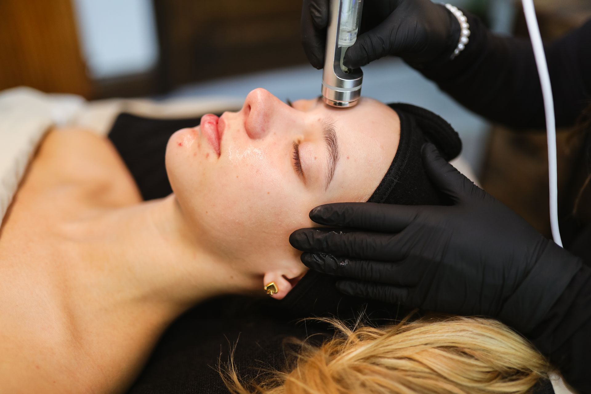 A woman is getting a facial treatment at a spa.