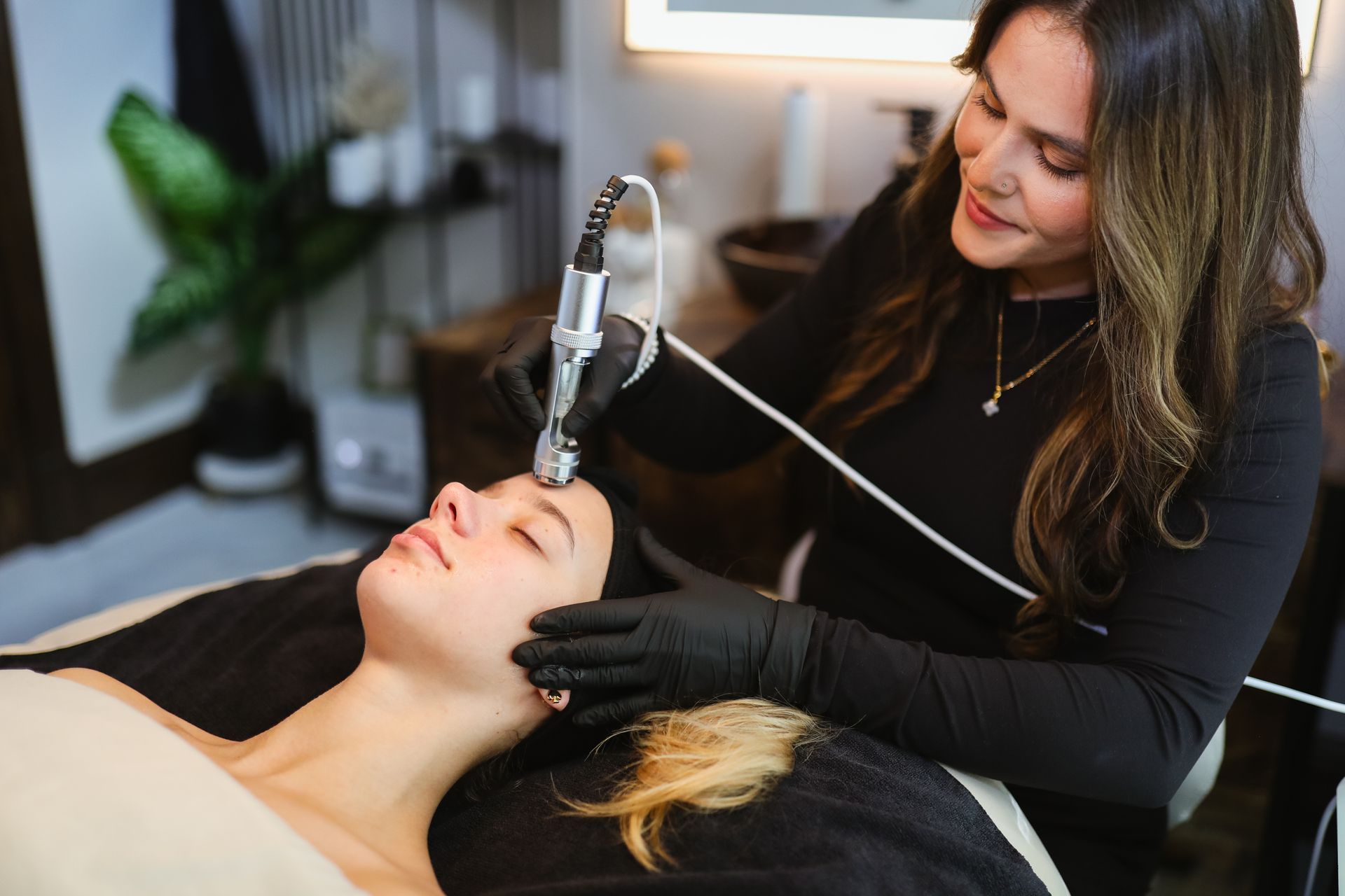 A woman is getting a facial treatment at a beauty salon.
