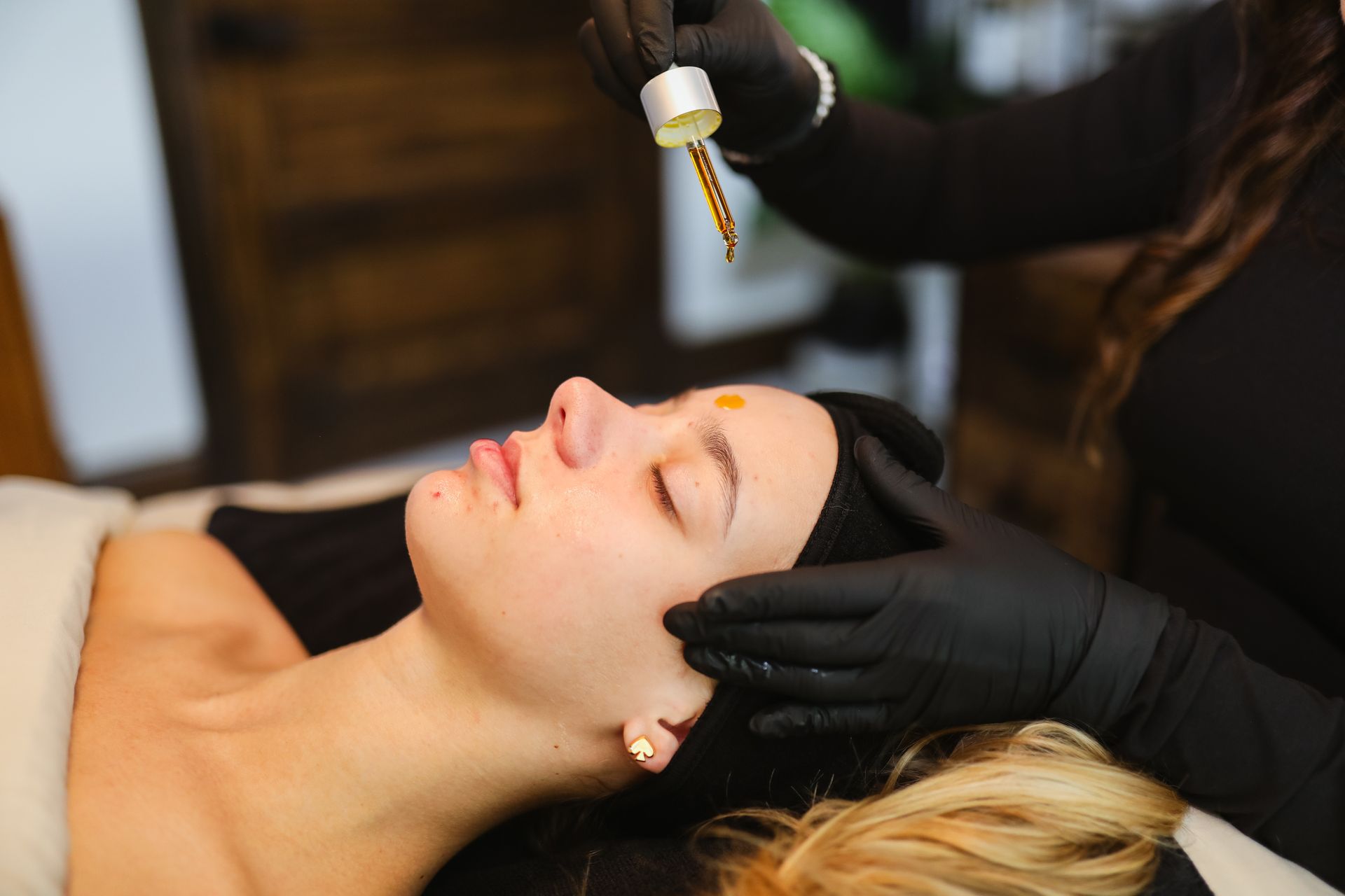 A woman is getting a facial treatment at a spa.