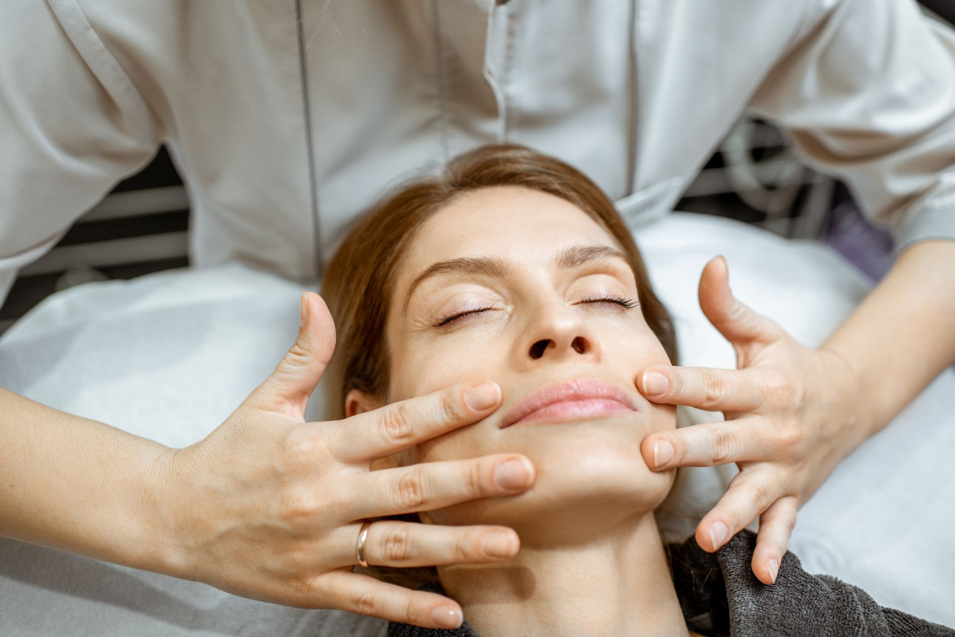 A woman is getting a facial treatment at a beauty salon.