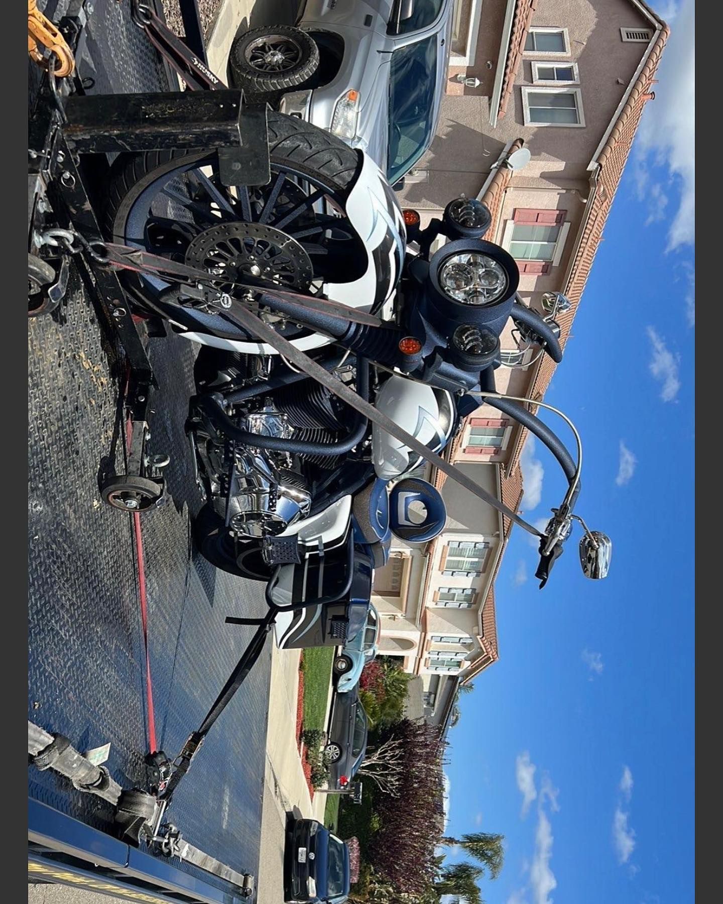 A motorcycle is being towed by a tow truck.