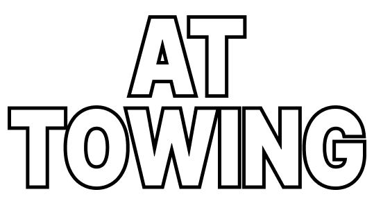 A black and white logo for AT Towing on a white background.