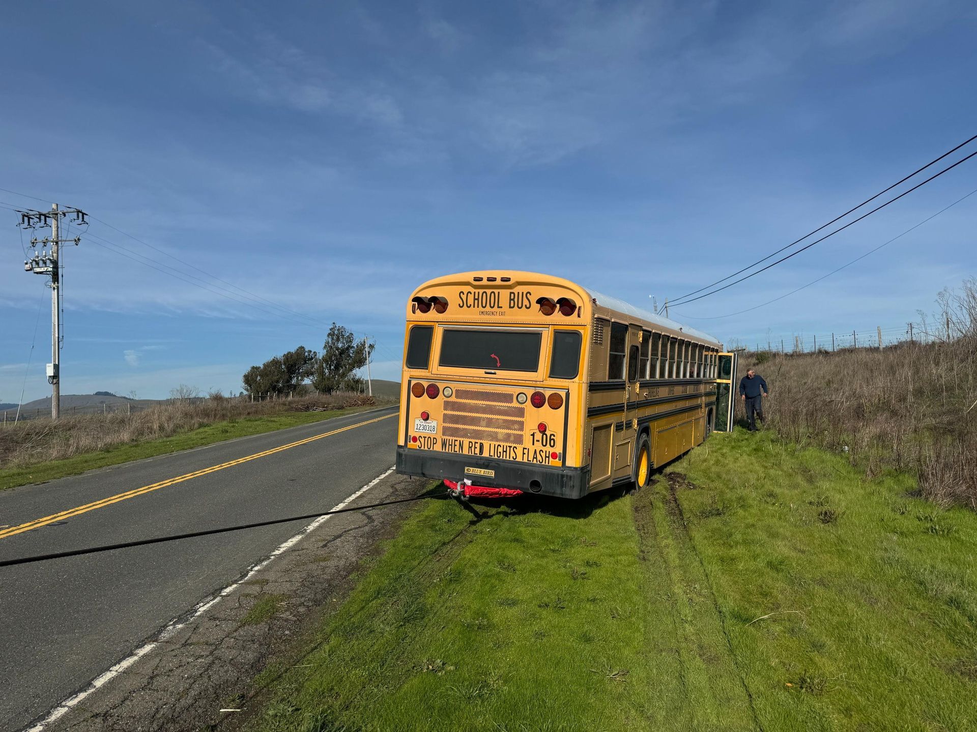 A yellow school bus is parked on the side of the road.