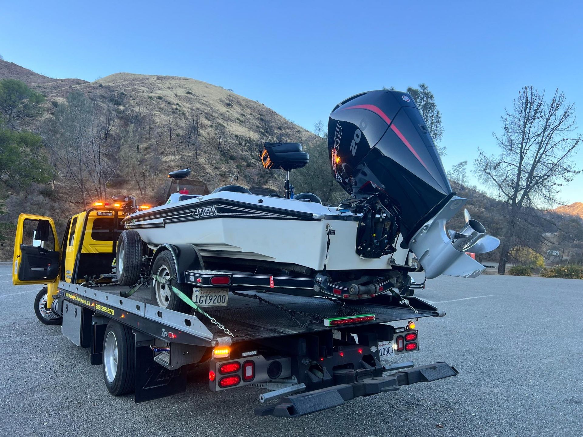 A boat is being towed by a tow truck.