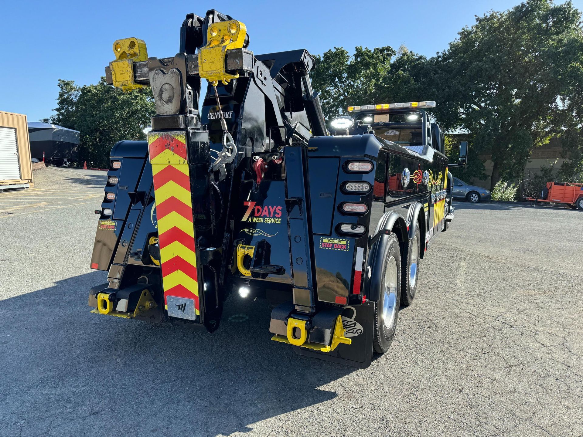 A tow truck is parked in a parking lot.
