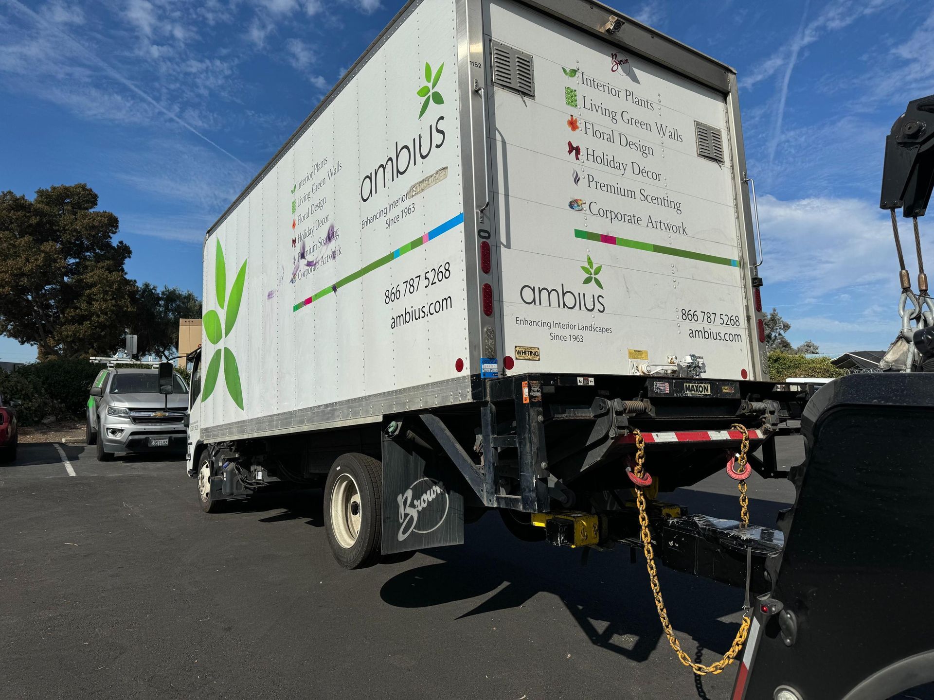 A white semi truck is parked on the side of the road.