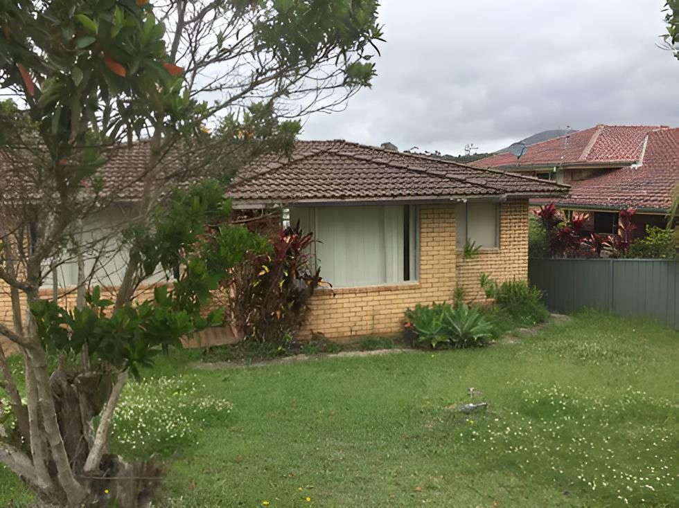 A Brick House With a Tiled Roof and a Large Lawn in Front of It — Aspex Construction - Lou Pieren In Port Macquarie, NSW