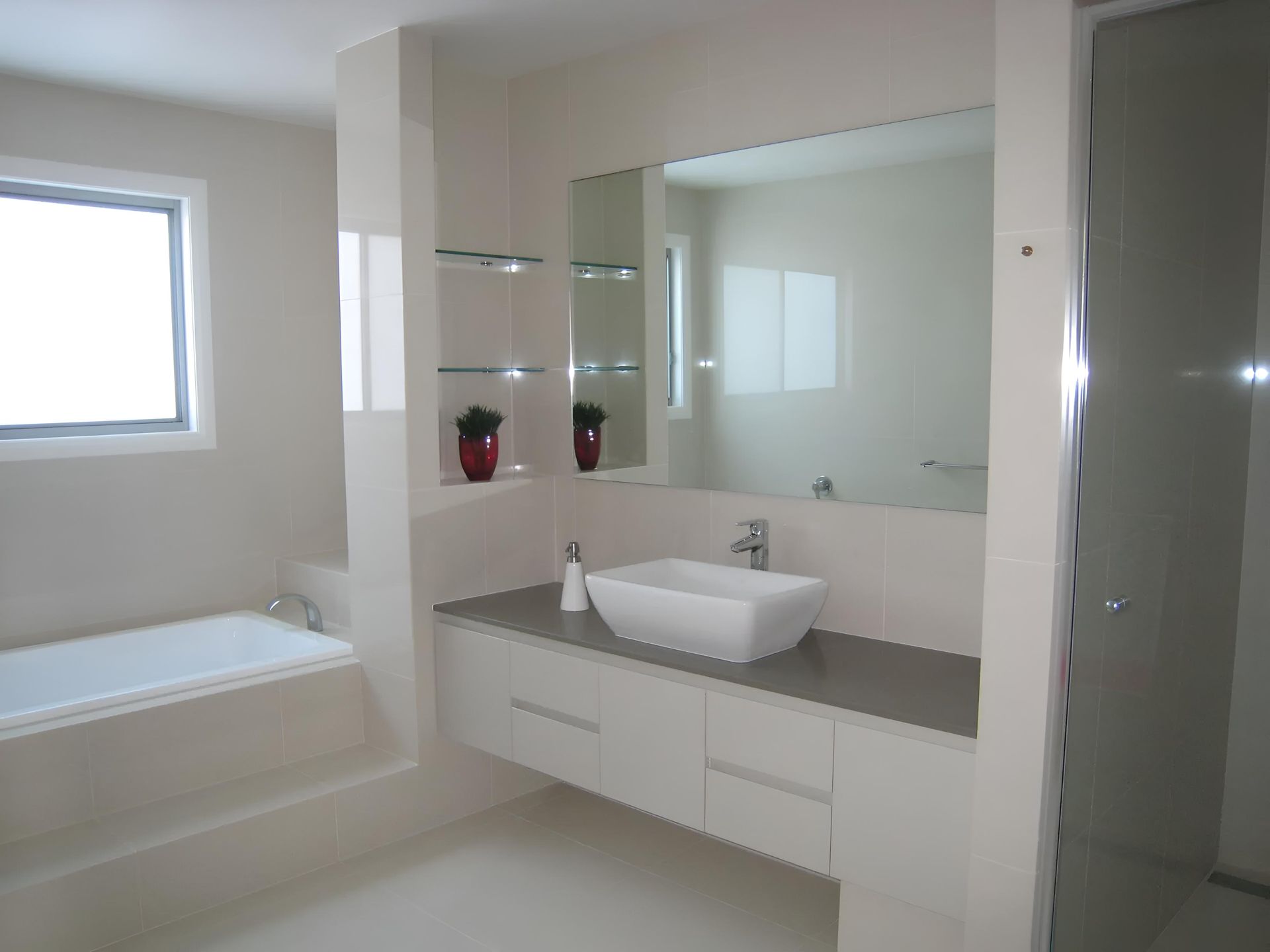 A Bathroom With a Sink and a Large Mirror — Aspex Construction - Lou Pieren In Port Macquarie, NSW