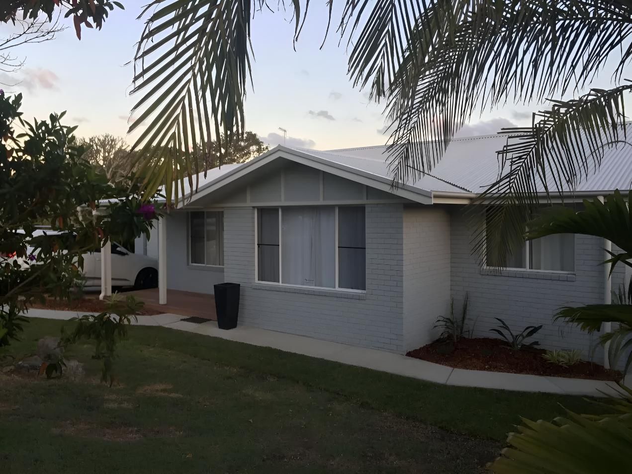 A White House With a White Car Parked in Front of It — Aspex Construction - Lou Pieren In Port Macquarie, NSW