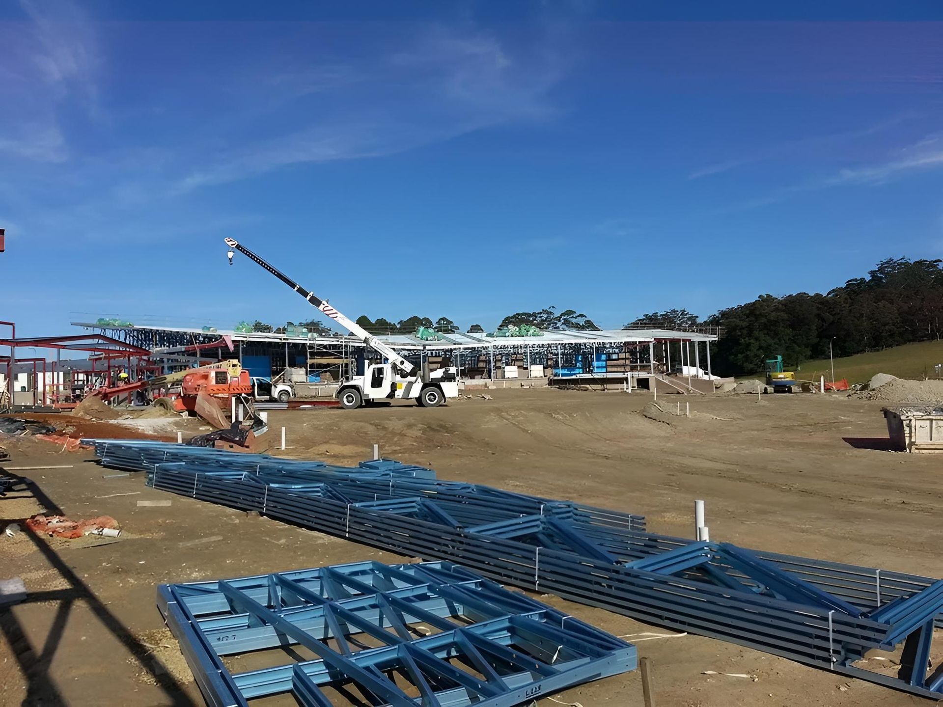 A Man is Working on a Concrete Floor in a Construction Site — Aspex Construction - Lou Pieren In Lake Cathie, NSW