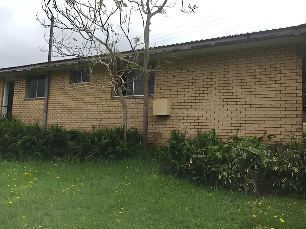 A Brick House With a Grassy Yard in Front of It — Aspex Construction - Lou Pieren In Port Macquarie, NSW