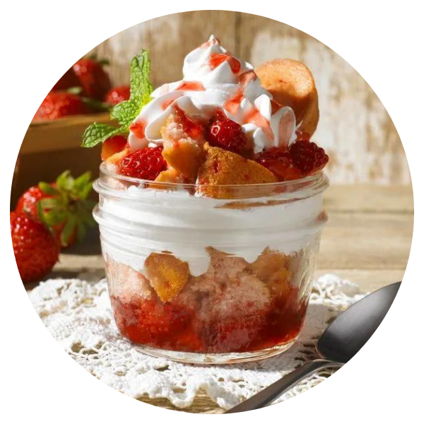 A strawberry dessert in a jar with whipped cream and strawberries