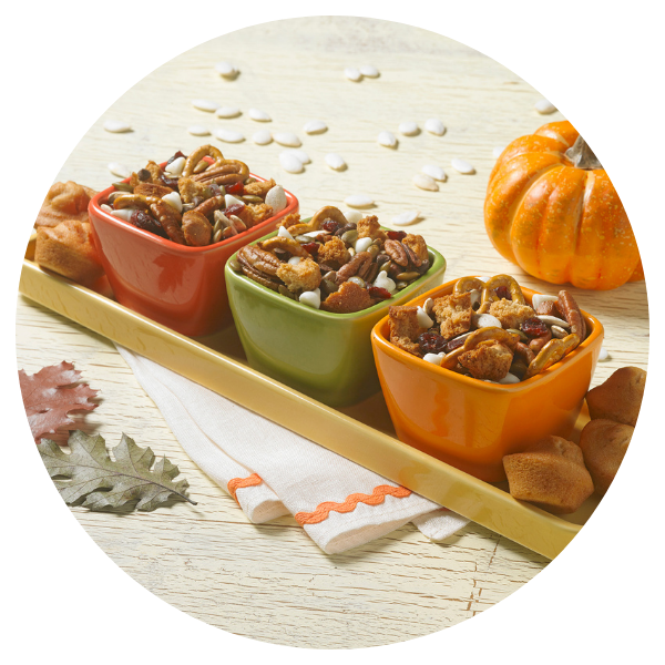 Three bowls of food on a tray with a pumpkin in the background