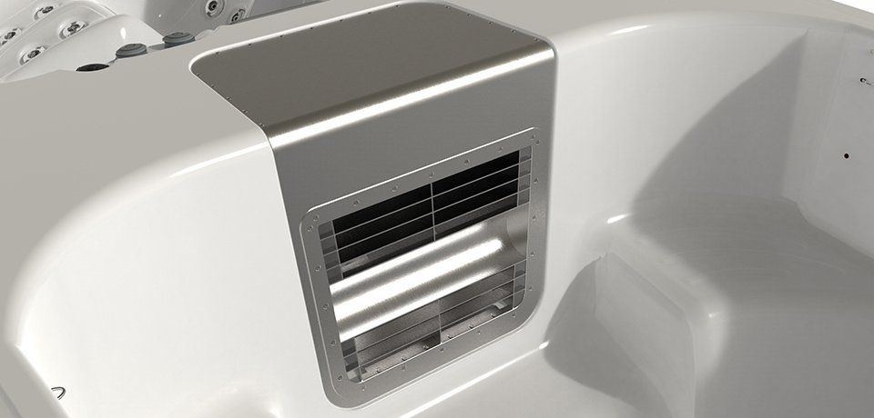 A close-up of a white hot tub with a stainless steel air vent.
