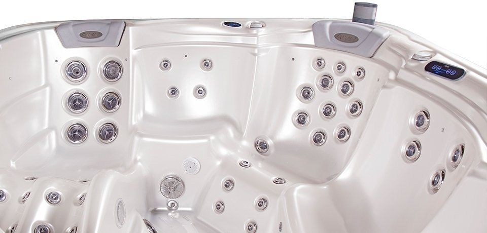 White hot tub with multiple jets and control panel.