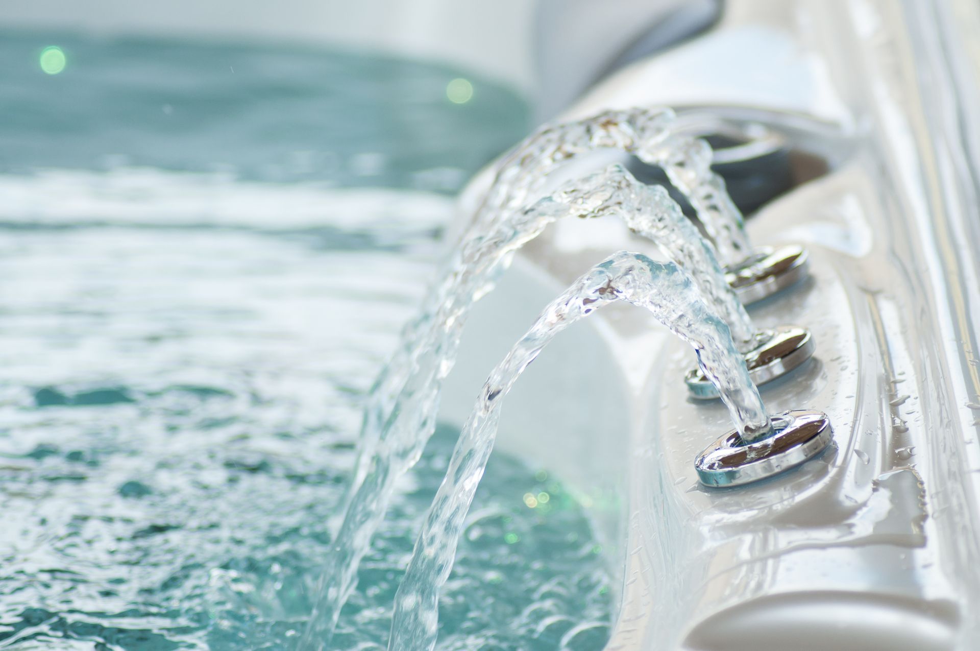 Close-up of water jets flowing into a hot tub, creating a relaxing bubbling effect.