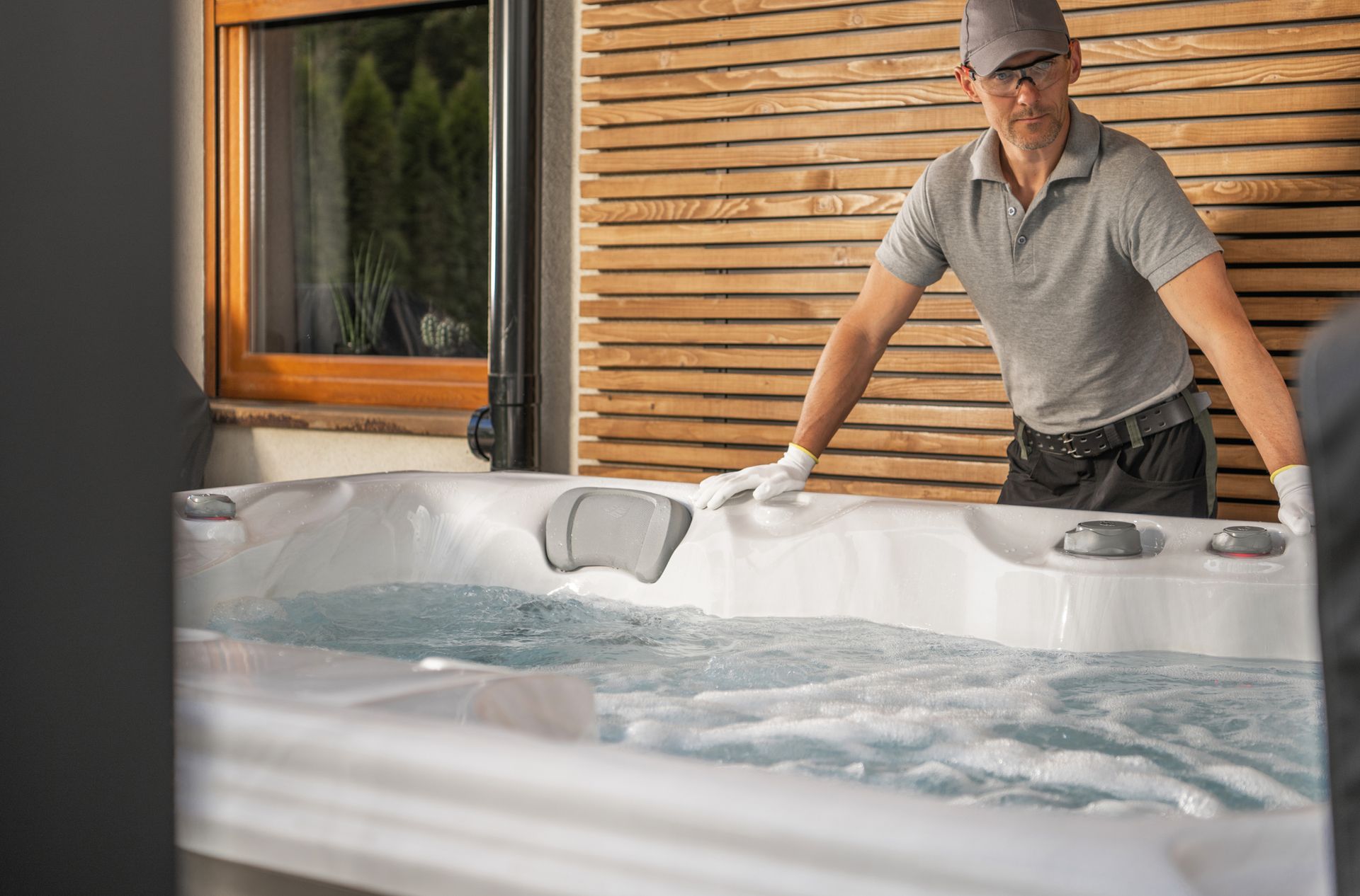 Hot tub dealer and technician servicing outdoor spa. Hot tub dealer and technician servicing outdoor spa.