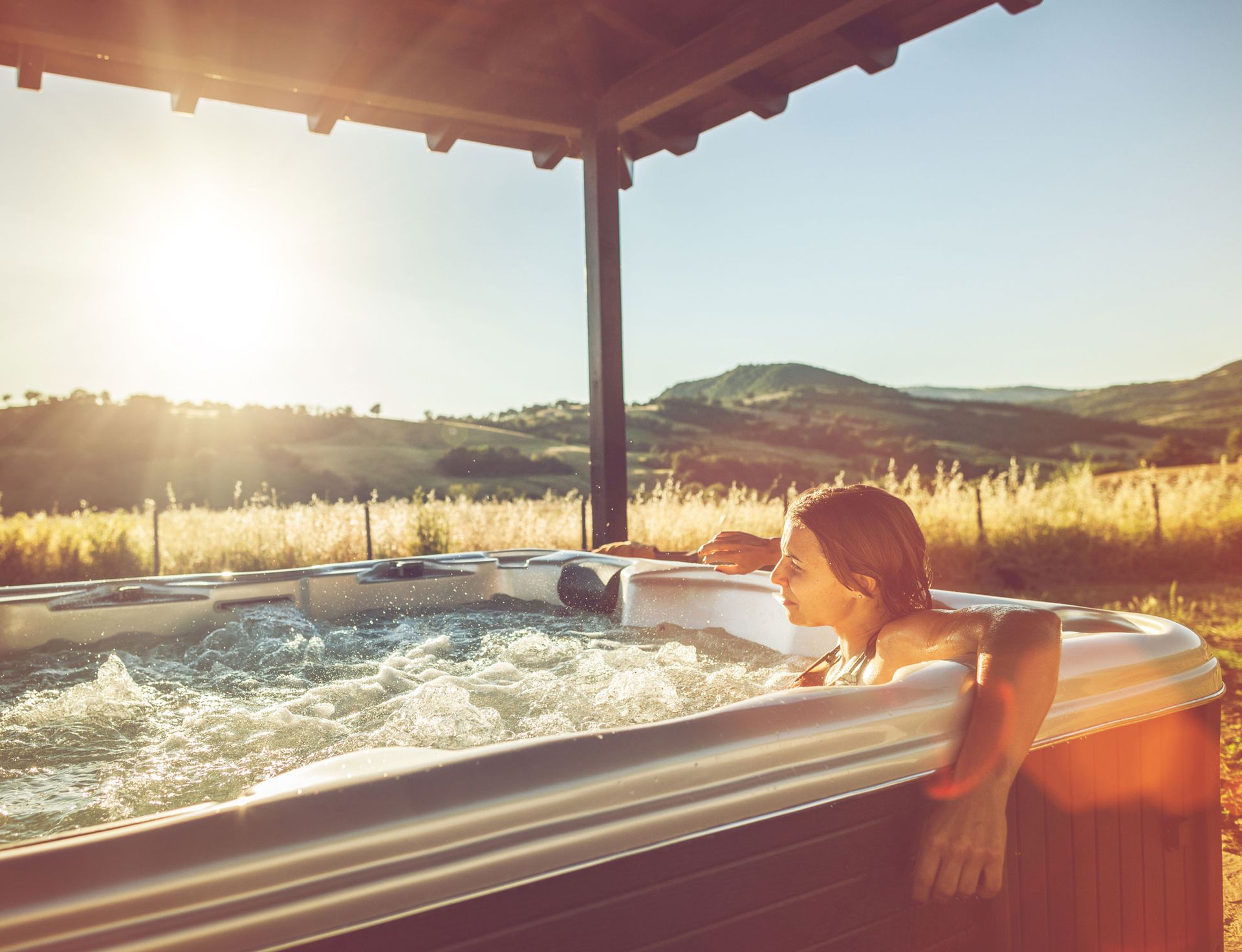 Woman relaxes in a hot tub installed by Wellis Hot Tubs of Colorado, expert hot tub dealers in Black