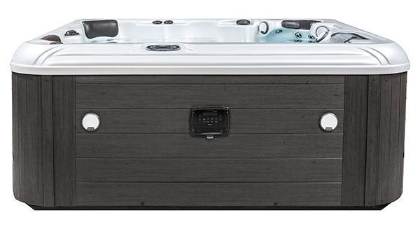 A rectangular hot tub with a white basin and dark gray wood-paneled exterior, featuring integrated headrests.