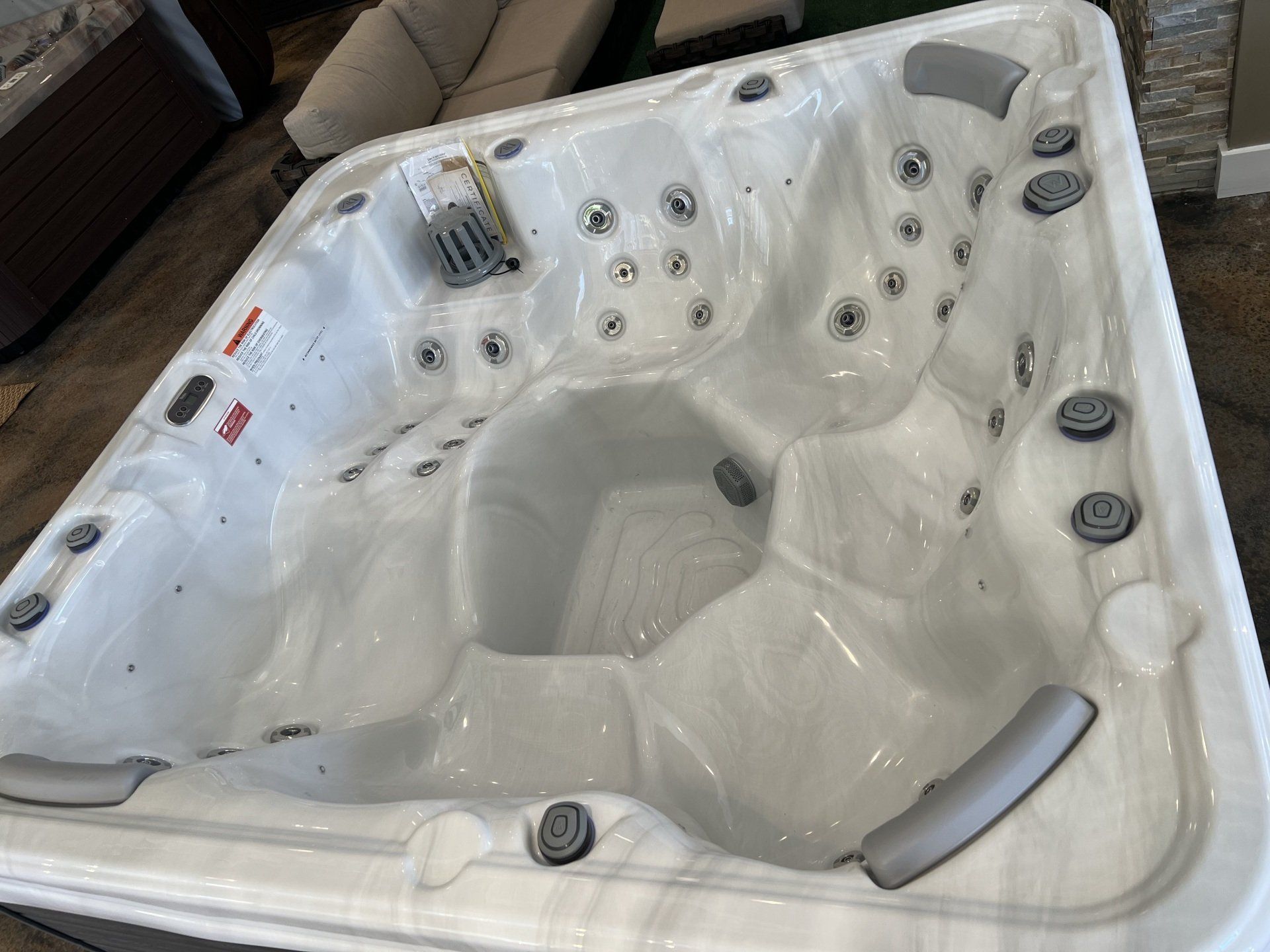 White hot tub with gray jets, inside view.
