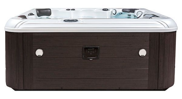 A rectangular hot tub with a dark brown, wood-paneled exterior and a white acrylic interior shell.