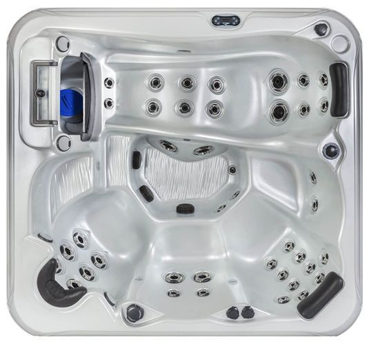 Top-down view of a square, silver hot tub with molded seats, headrests, and multiple water jets.