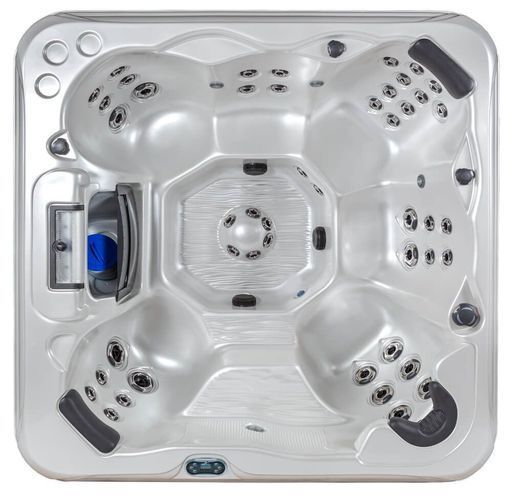 Top-down view of a light-colored, square, five-seat hot tub with integrated headrests and multiple water jets.