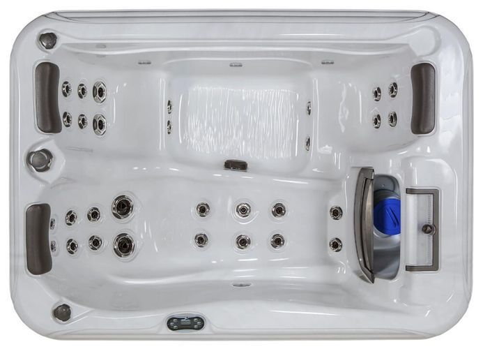 Top-down view of a white rectangular hot tub with molded seats, headrests, and integrated water jets.