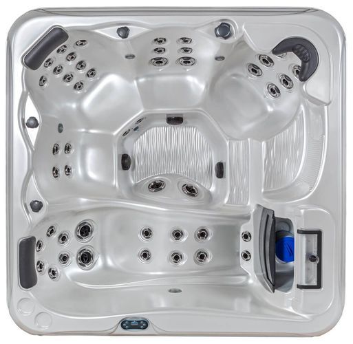 Top-down view of a square, light-gray hot tub with multiple contoured seats, headrests, and integrated water jets.