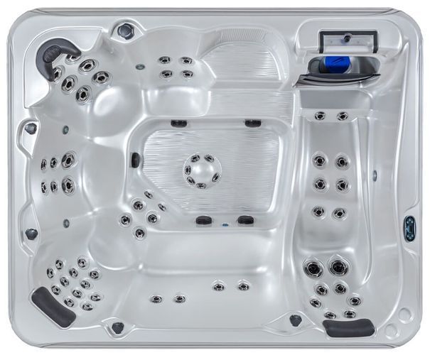 Top-down view of an empty, silver-colored hot tub featuring multiple molded seats, headrests, and numerous water jets.