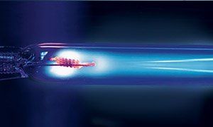 Blue-glowing UV lamp, with a bright center and a dark background.