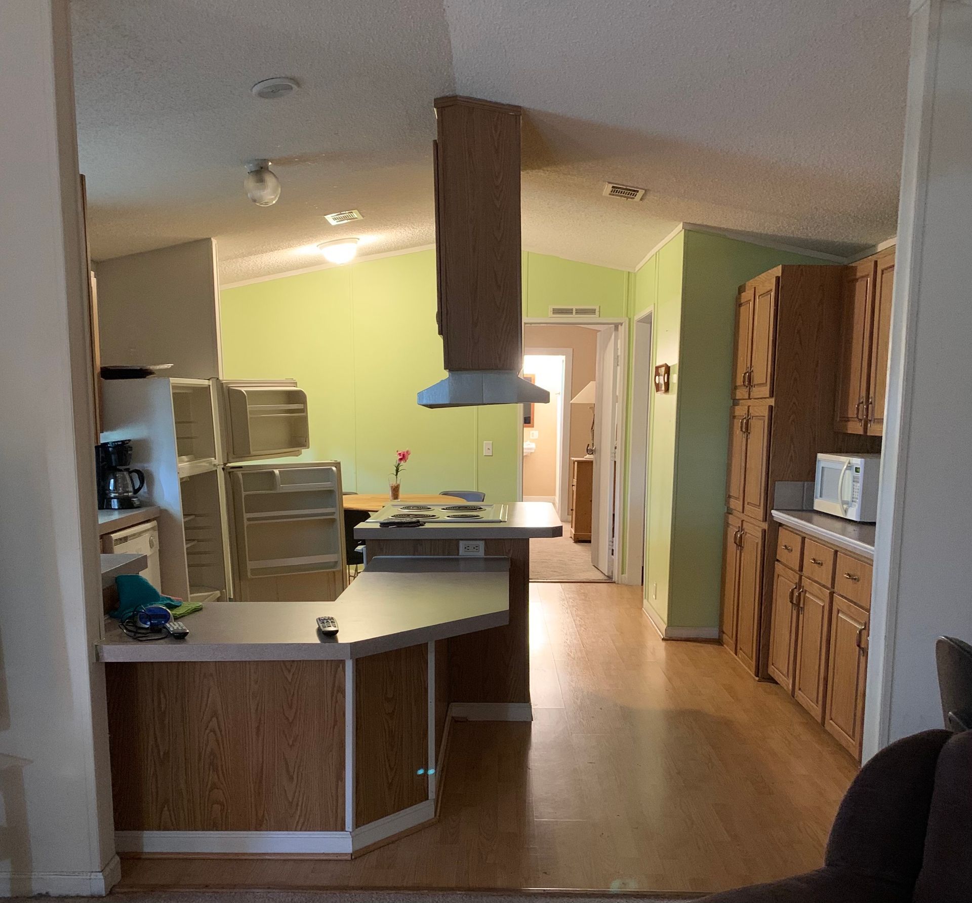 A living room with a couch and chairs and a ceiling fan