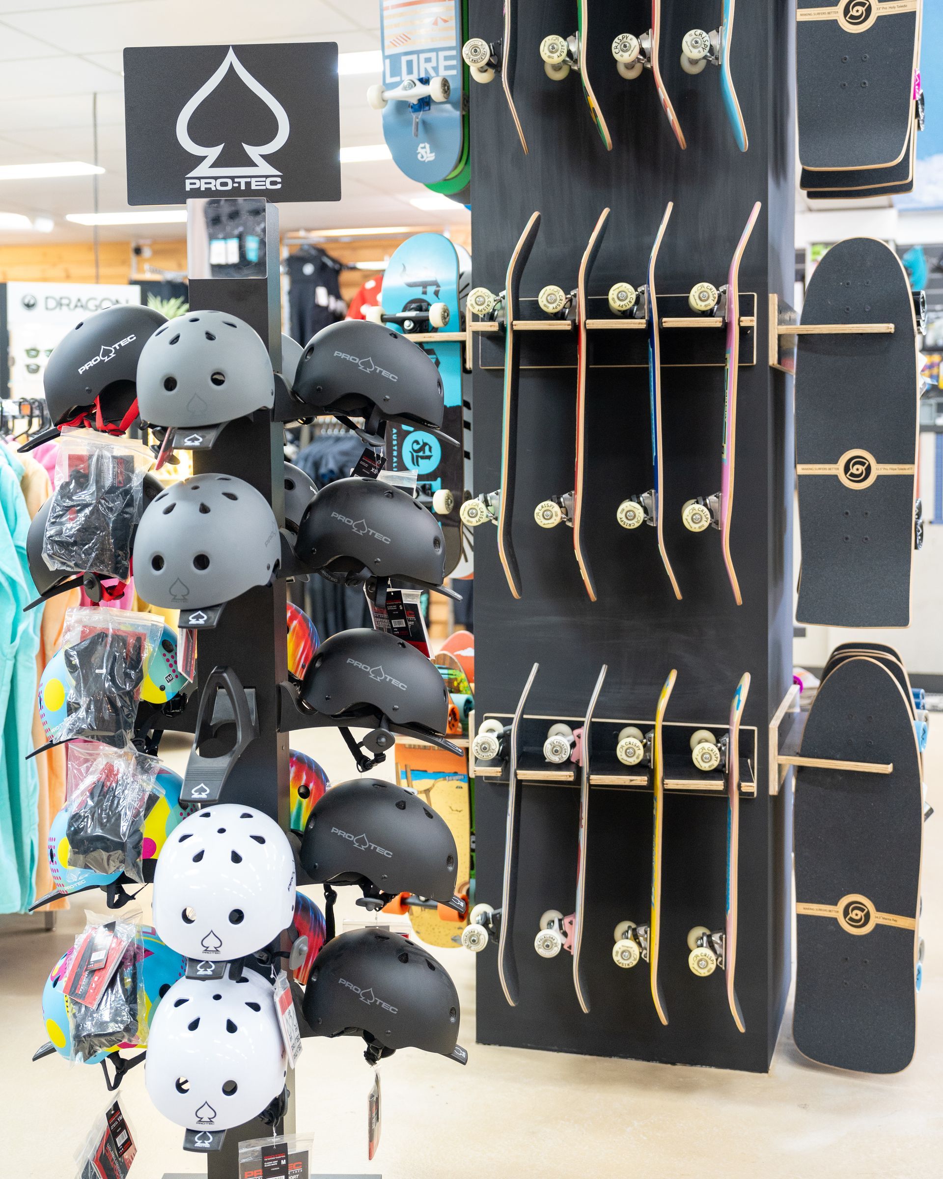 A Display of Skateboards and Helmets in A Store — Slimes Boardstore in Erina, NSW