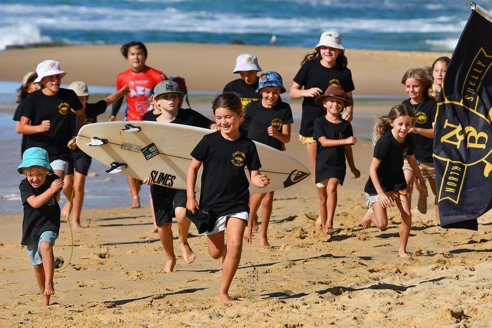 Surf Shop Owner Displaying Surfboards in Store — Slimes Boardstore in Erina, NSW