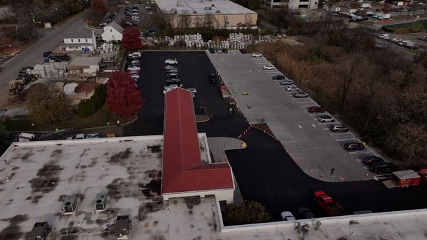 An aerial view of a parking lot with a red roof