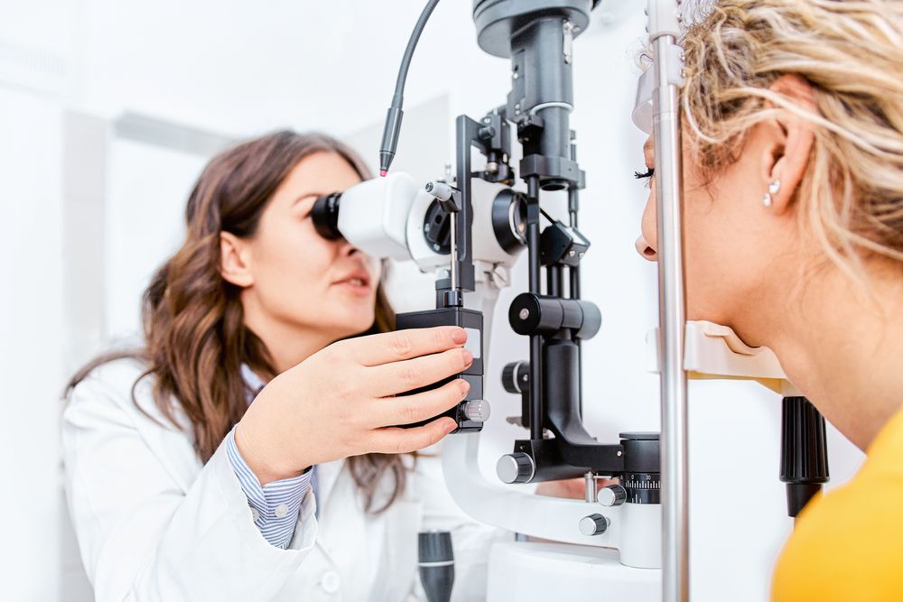 A Woman Is Getting Her Eyes Examined by An Ophthalmologist — John Williams Optometrist in Grafton, NSW