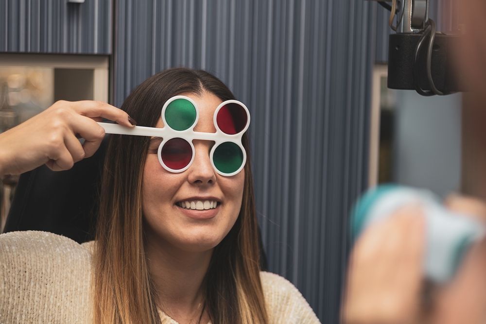 A Woman Is Getting Her Eyes Checked by An Ophthalmologist — John Williams Optometrist in Grafton, NSW